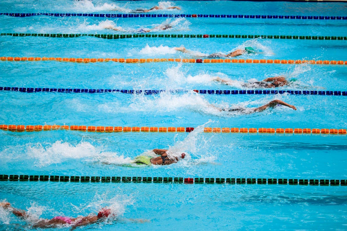 Swim instructor teaching a young student in the pool